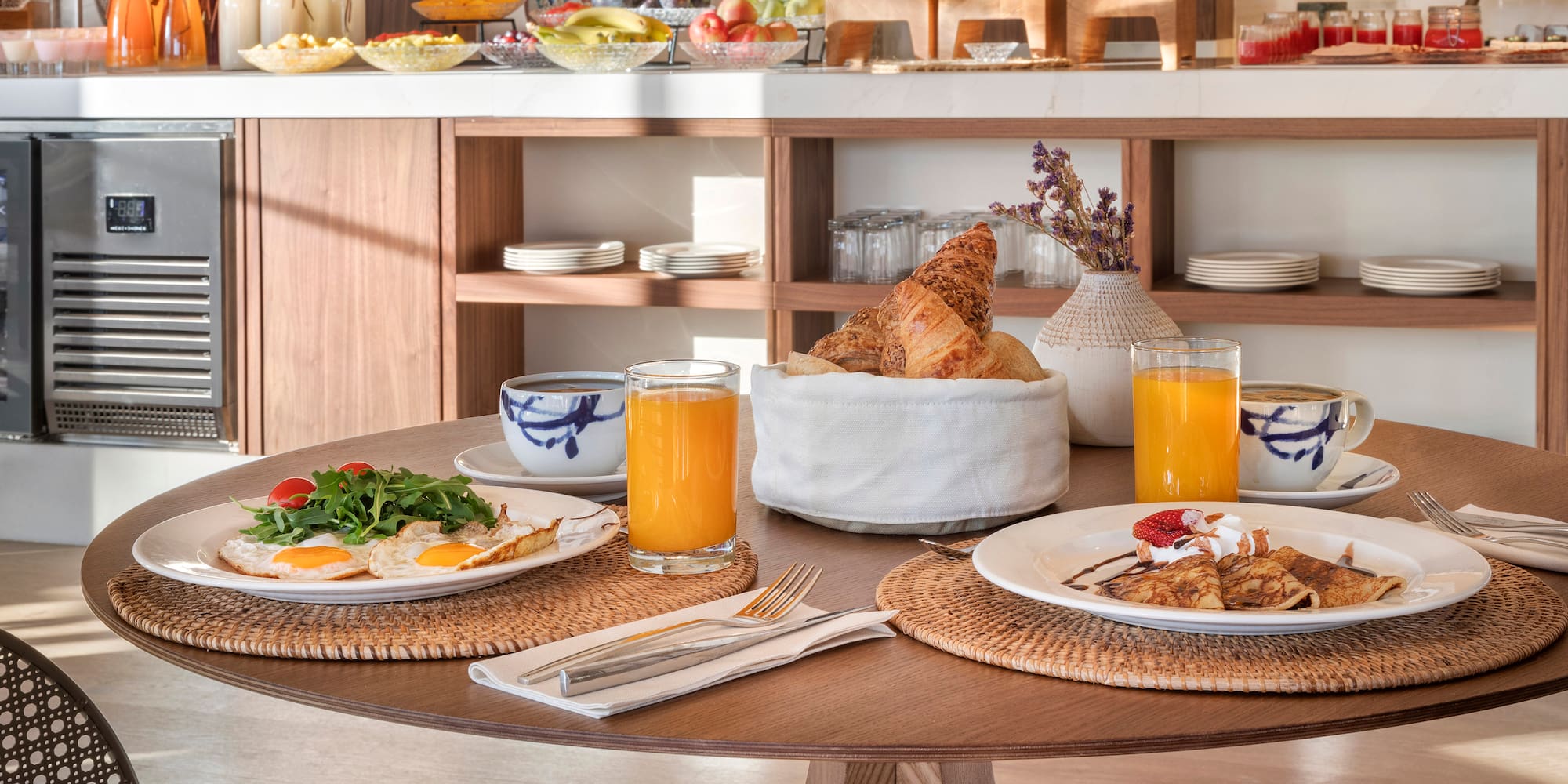 a table with plates of food and drinks
