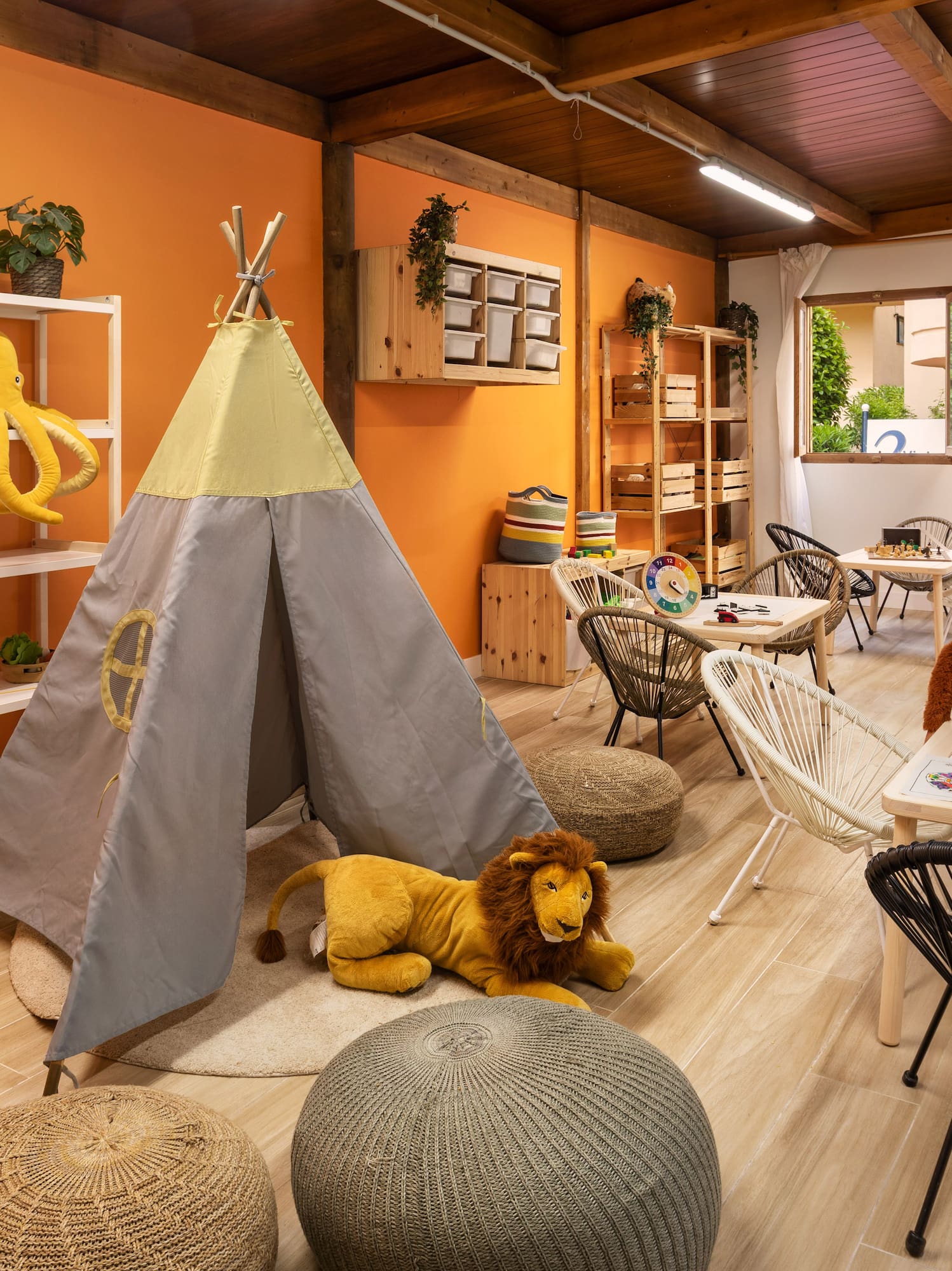 a room with a teepee and stuffed animals
