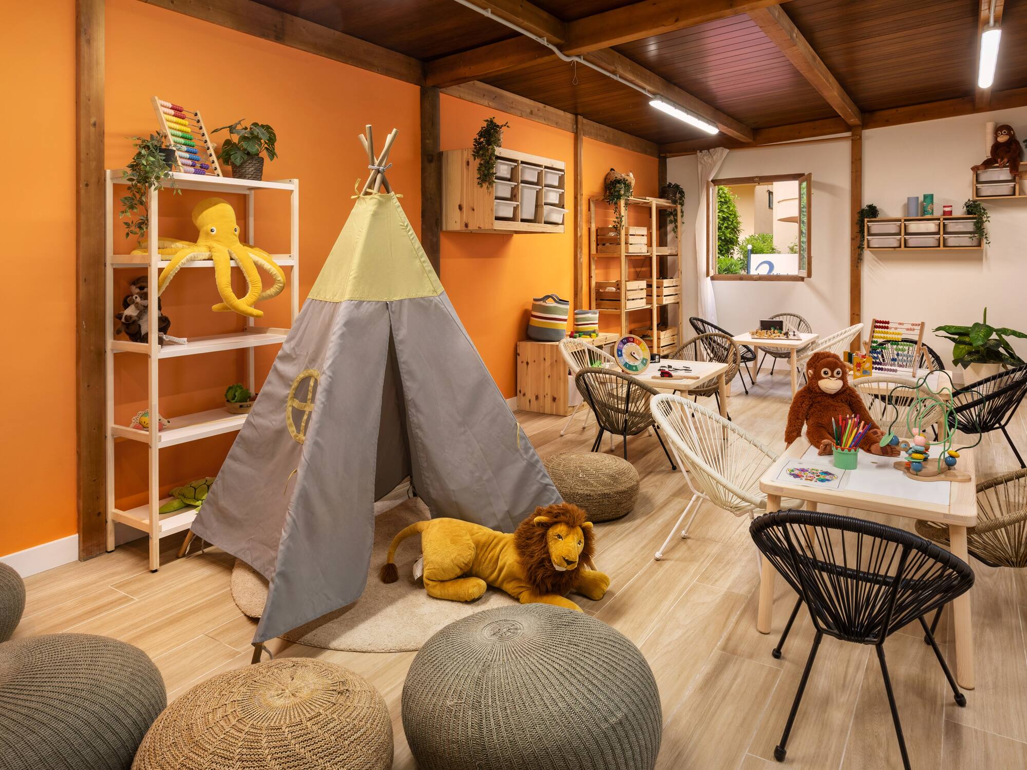 a room with a teepee and stuffed animals