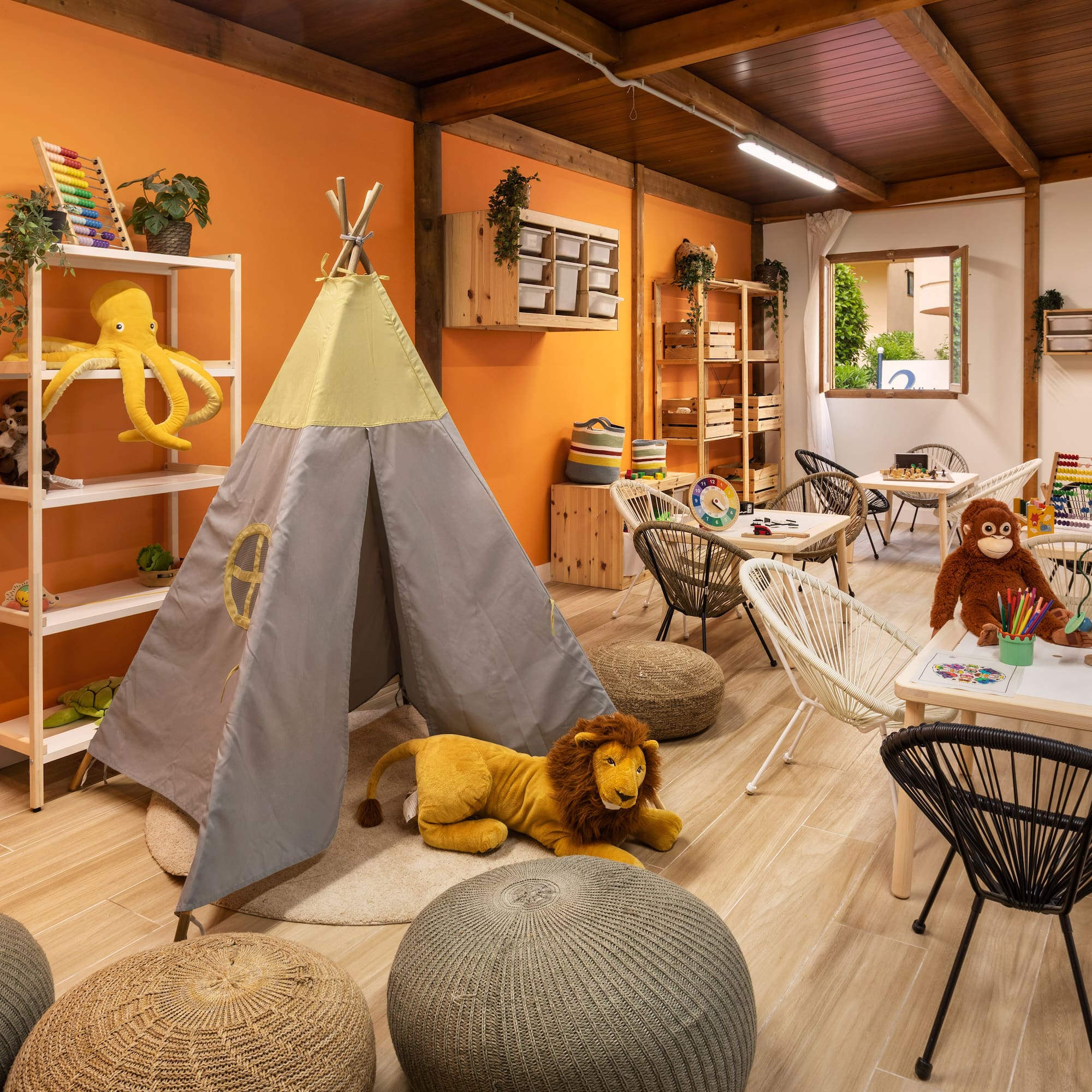 a room with a teepee and stuffed animals
