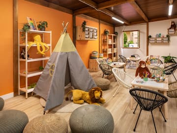 a room with a teepee and stuffed animals