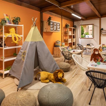 a room with a teepee and stuffed animals