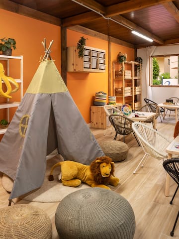 a room with a teepee and stuffed animals