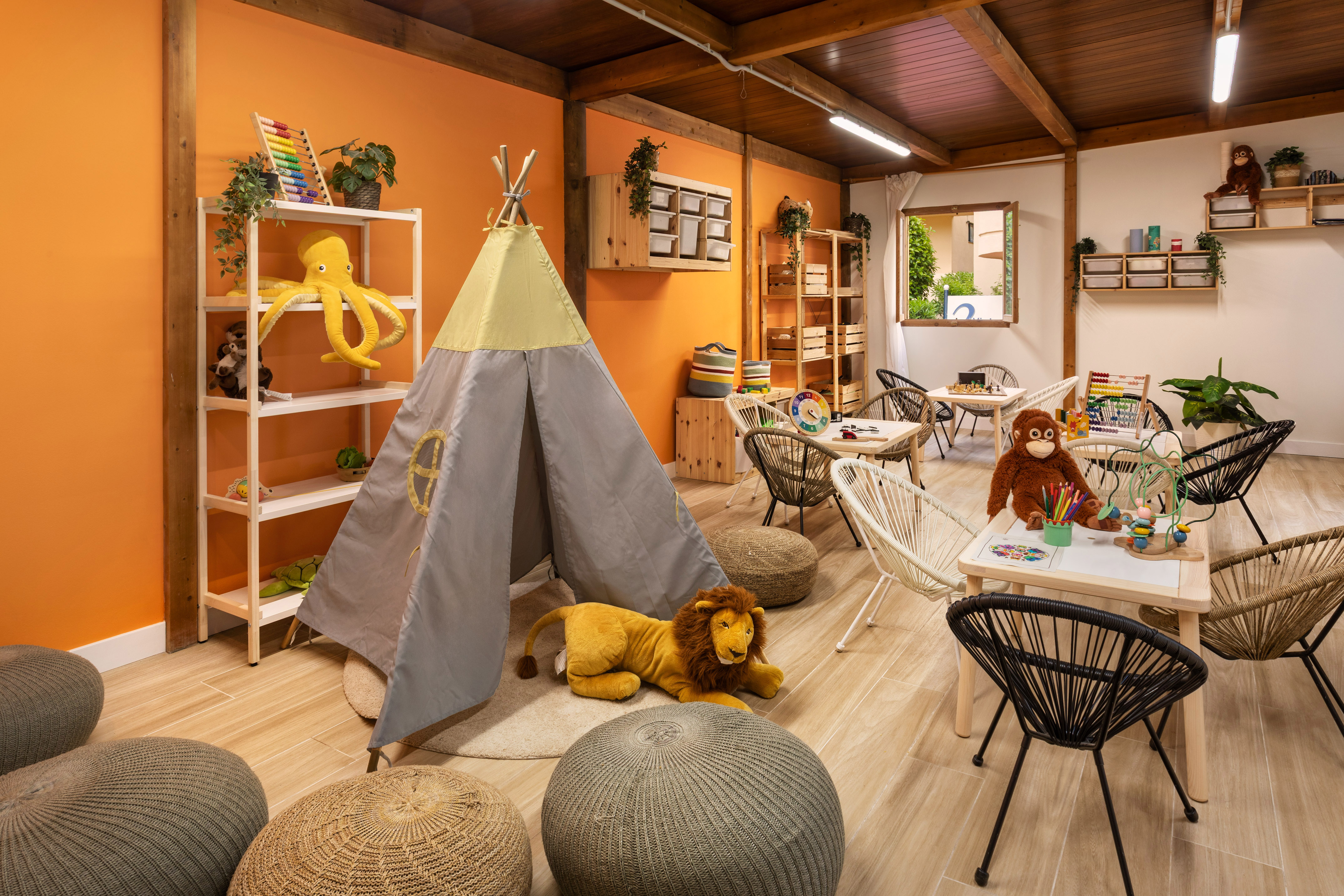 a room with a teepee and stuffed animals