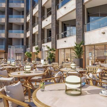 a group of tables and chairs outside of a building