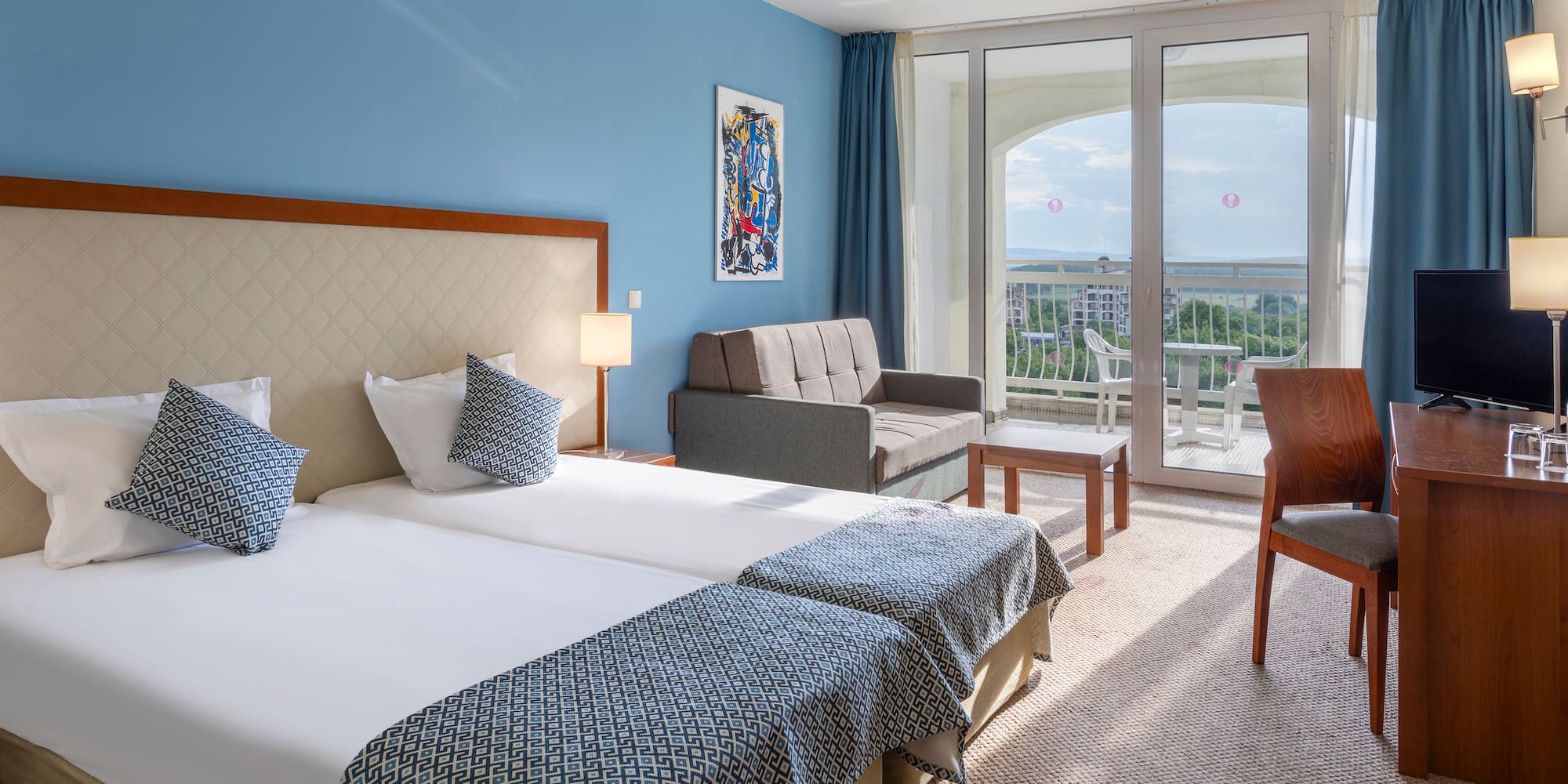 a room with two beds and a couch