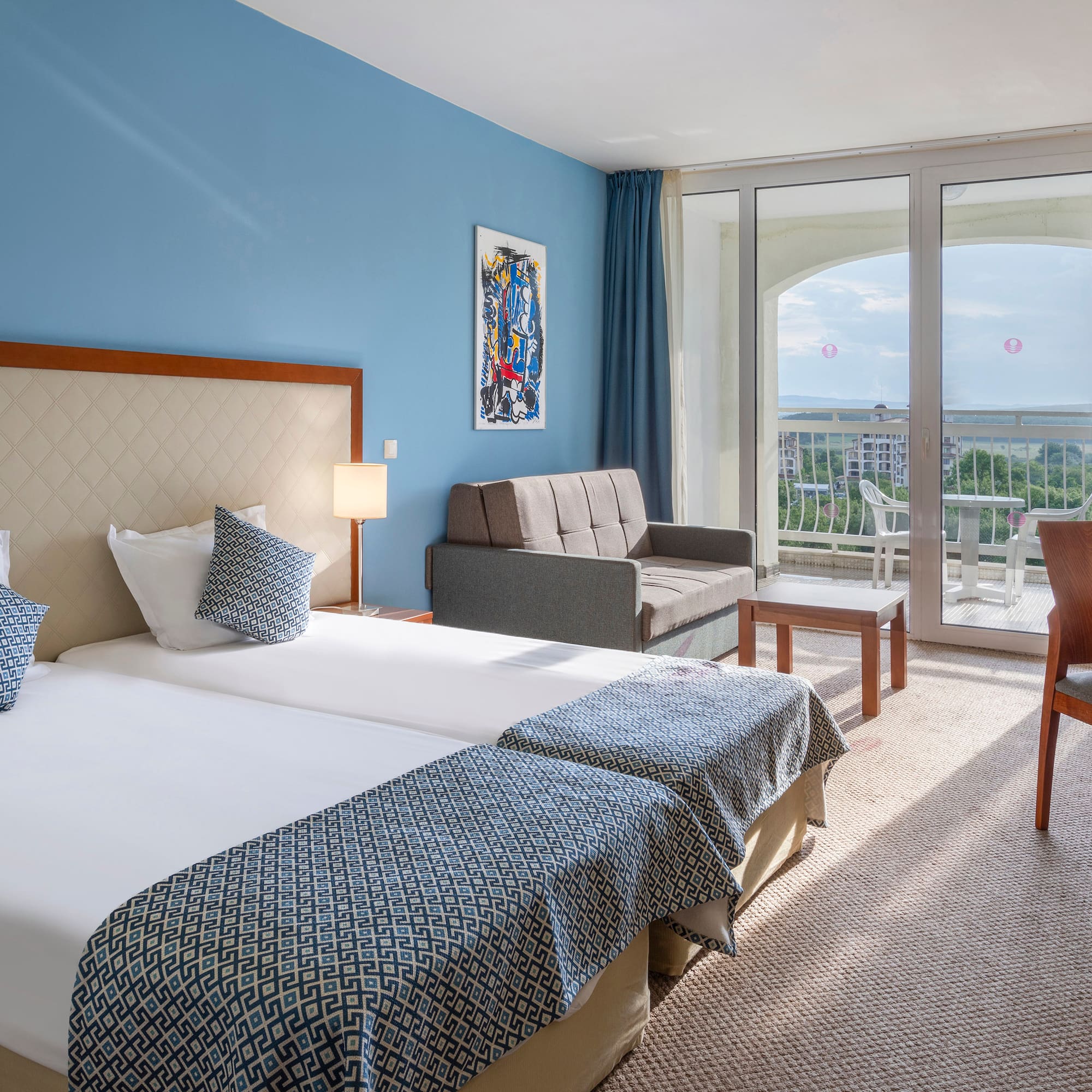 a room with two beds and a couch