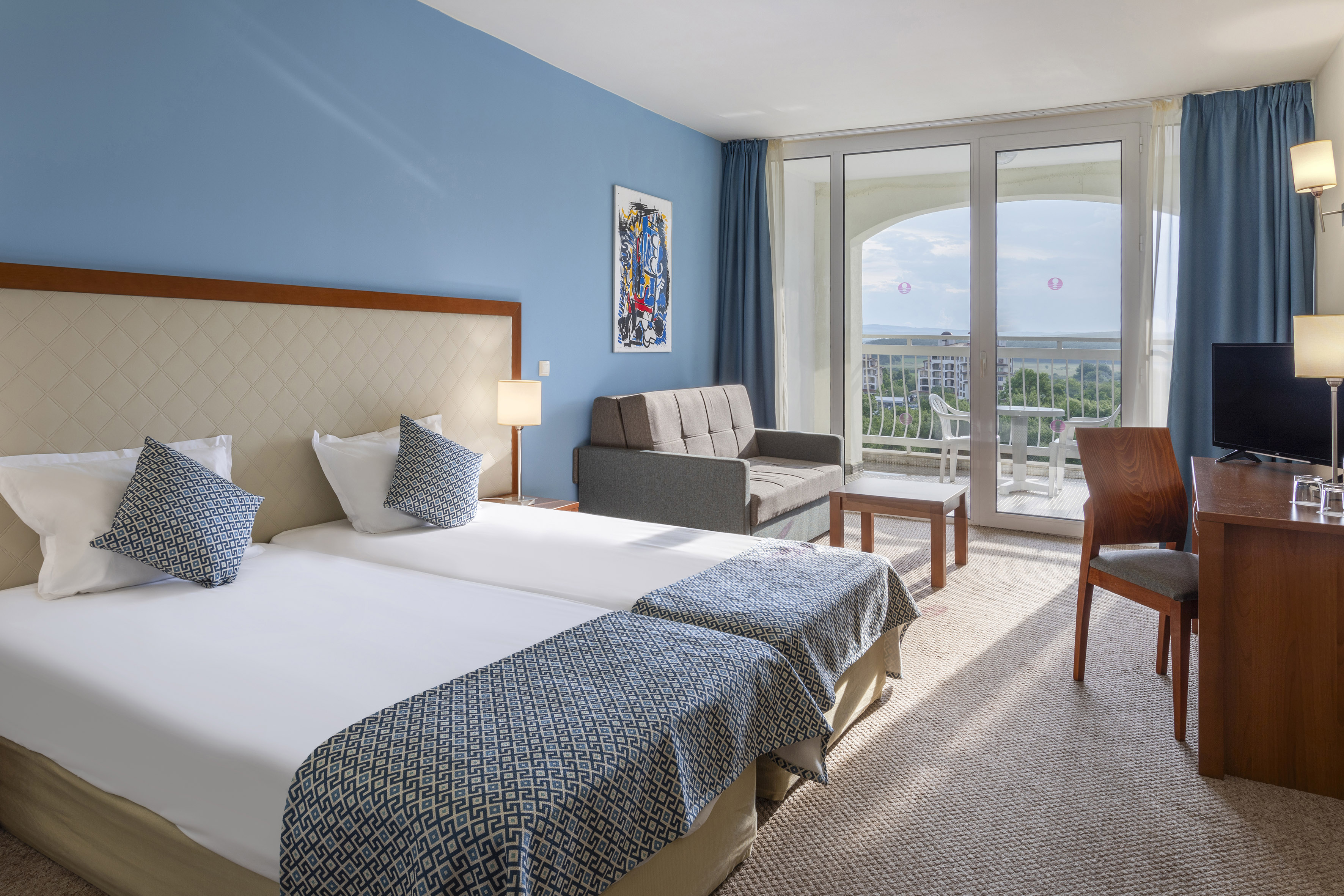 a room with two beds and a couch