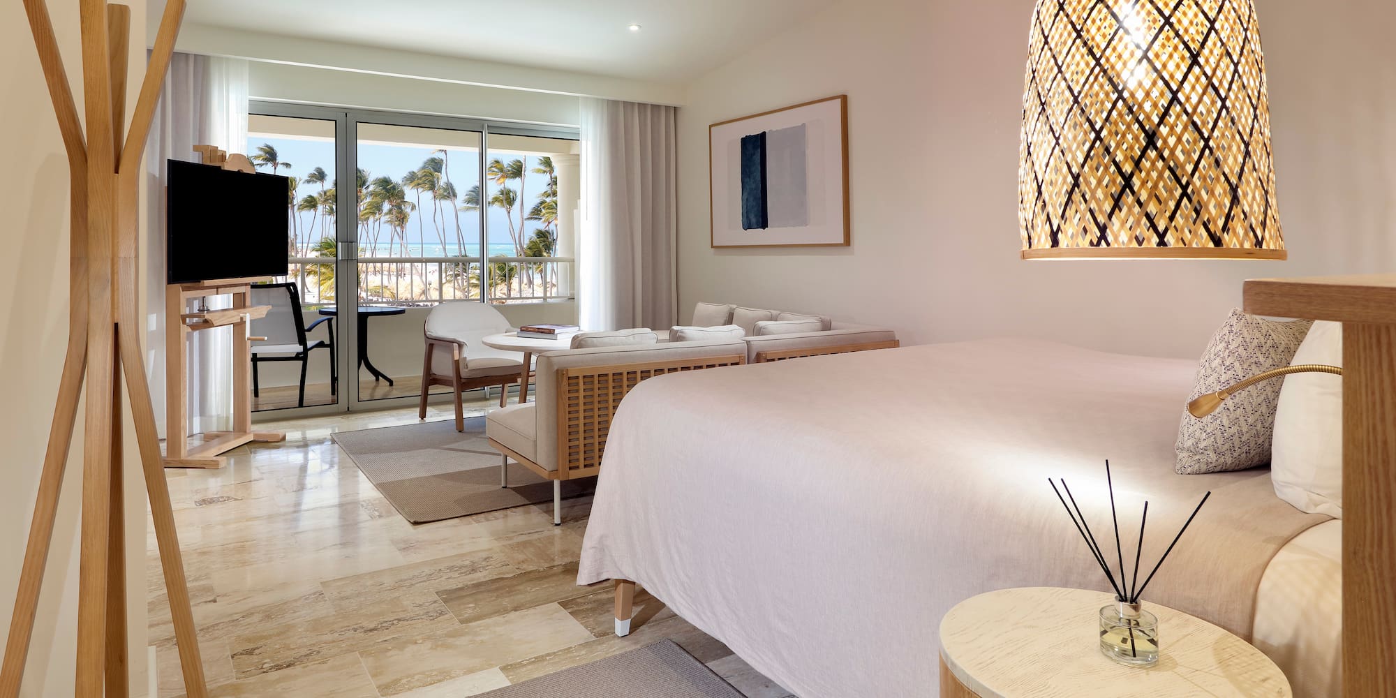 a room with a bed and a table and chairs