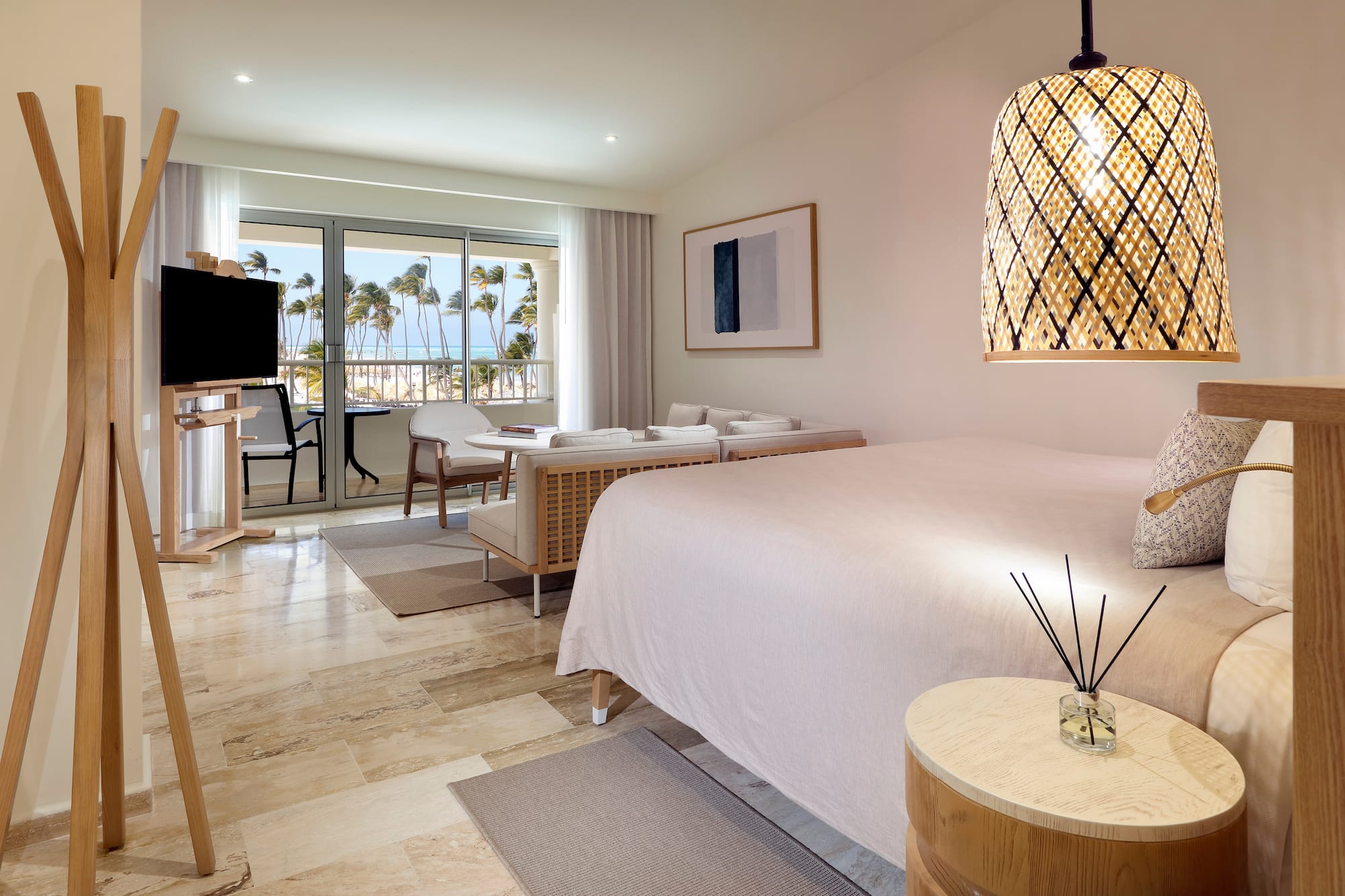 a room with a bed and a table and chairs