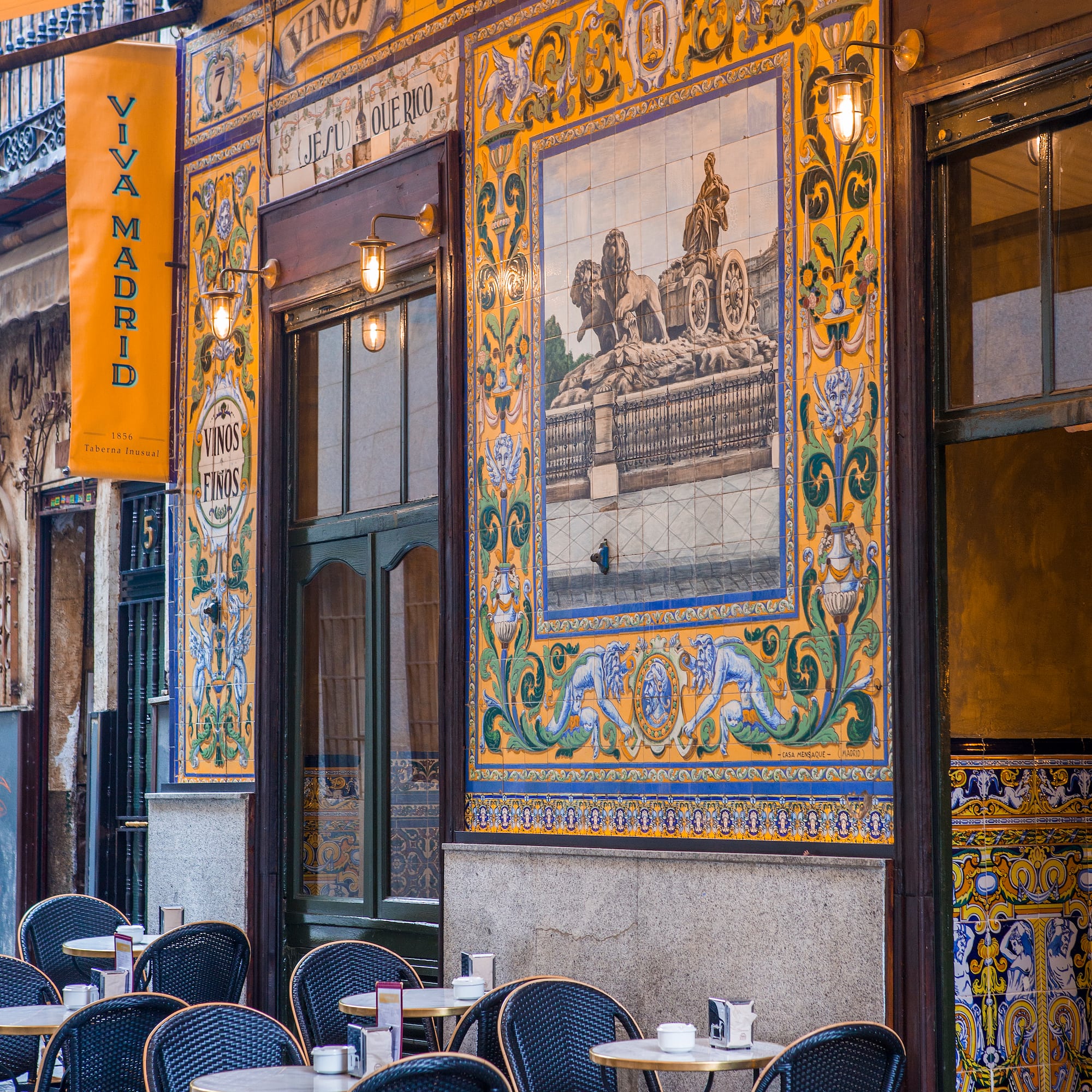 a restaurant with tables and chairs outside
