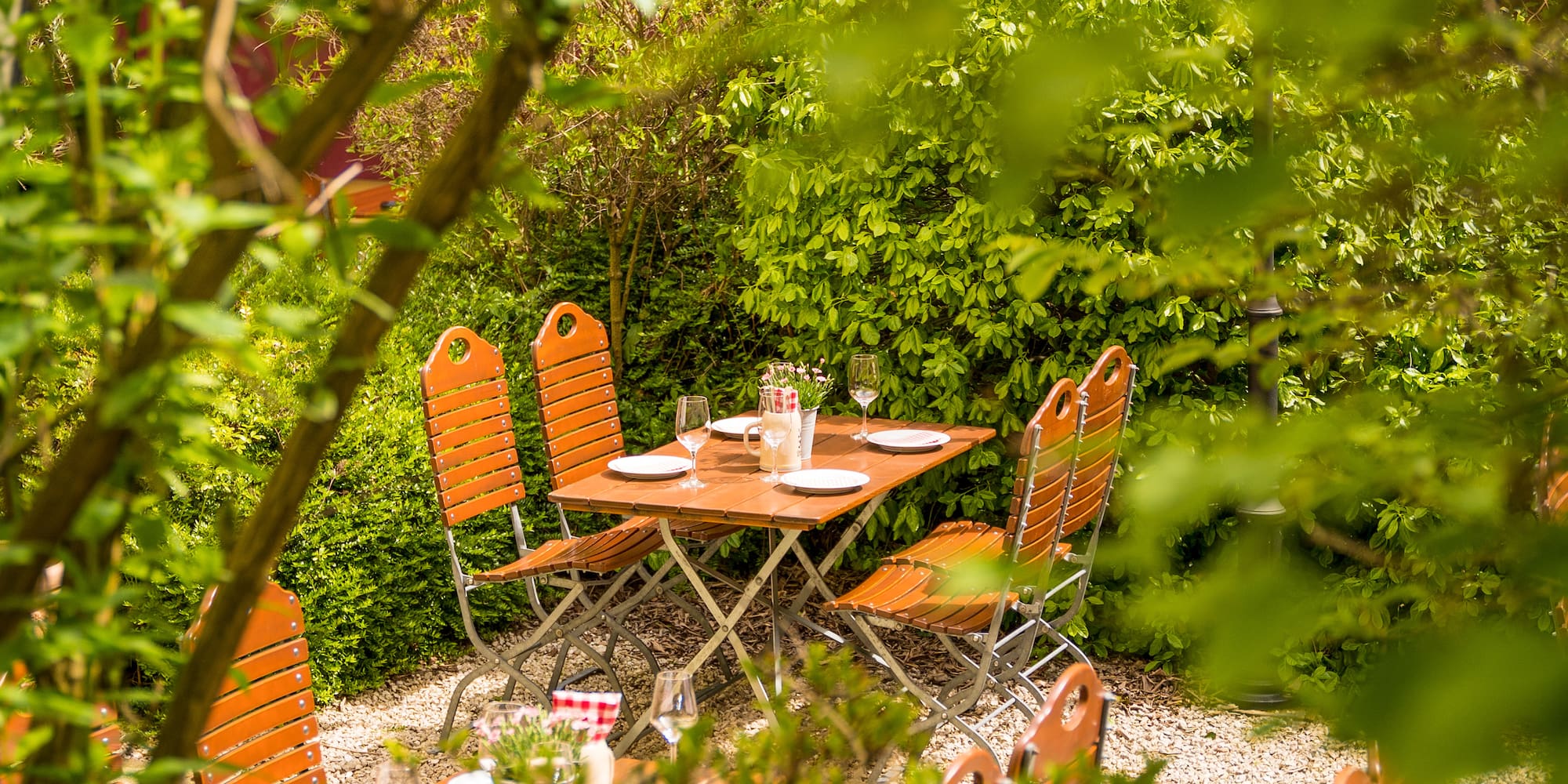 a table and chairs in a garden