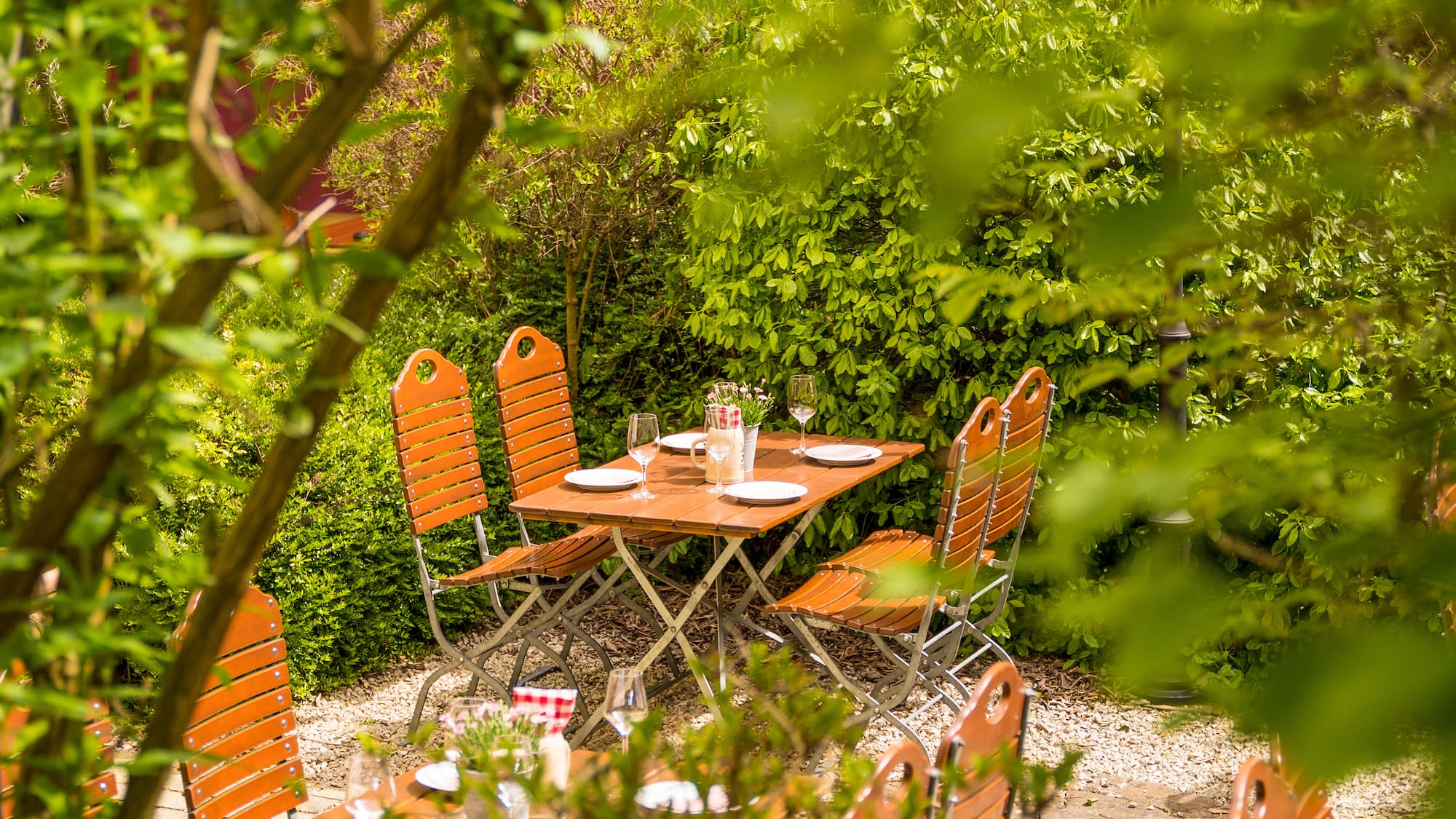 a table and chairs in a garden