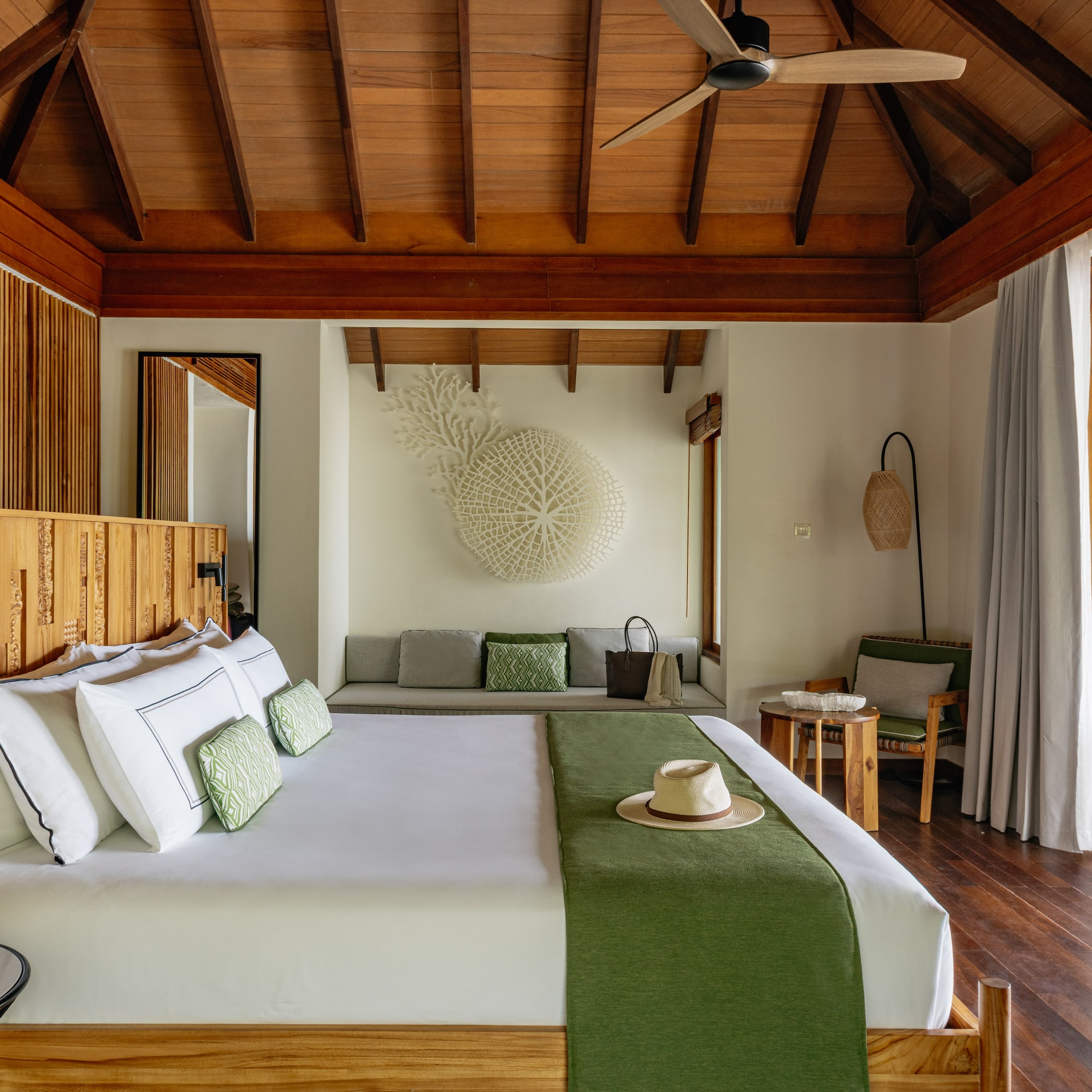 a room with a bed and a fan