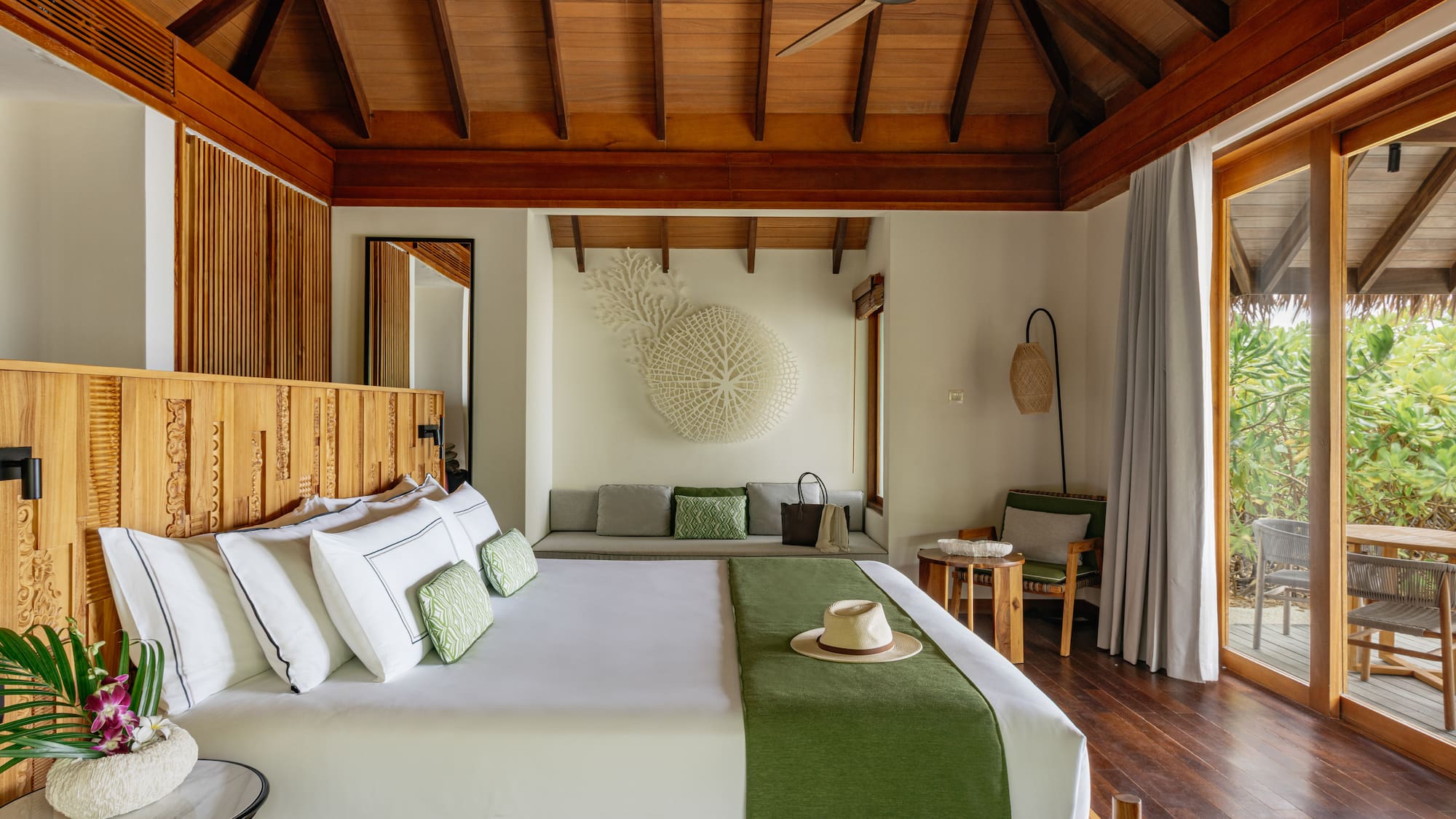 a pool and a red umbrella on a beach