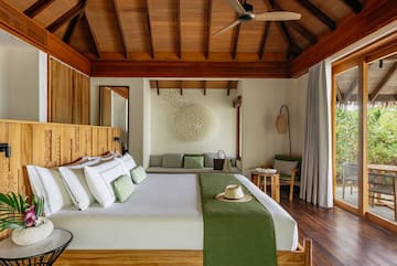 a room with a bed and a fan