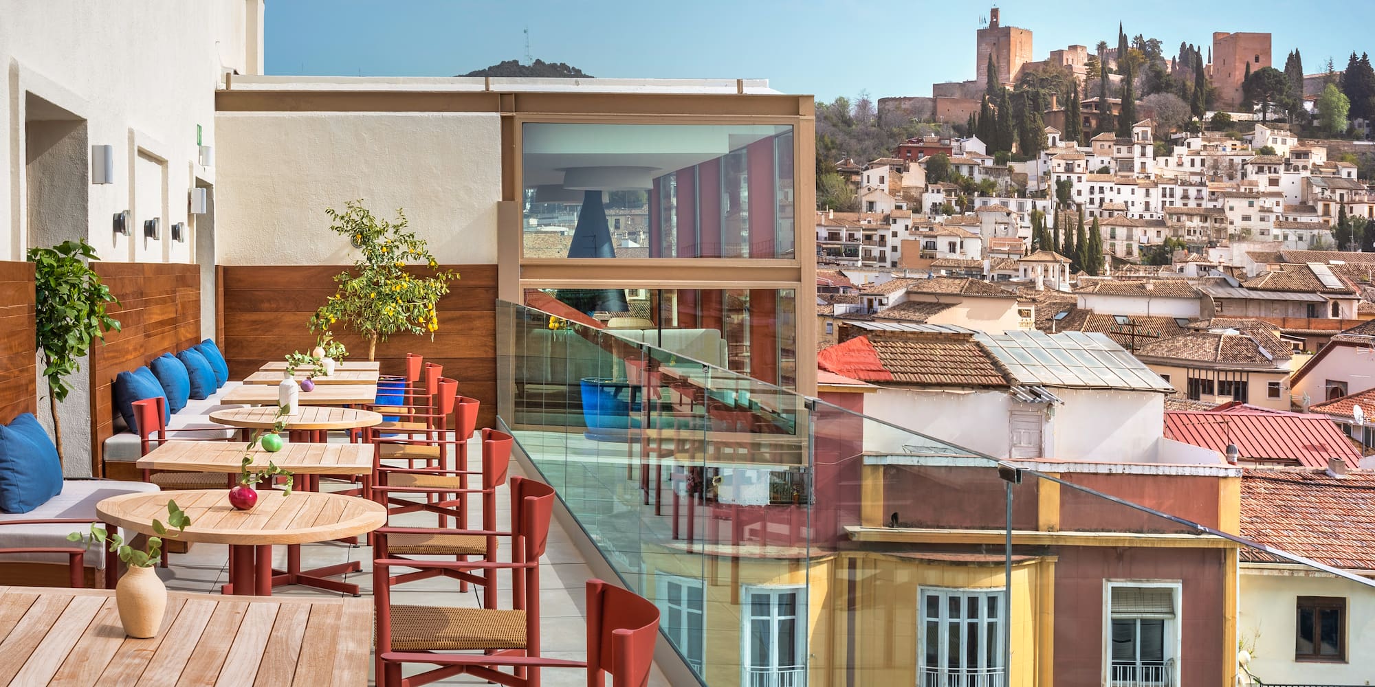 a table and chairs on a balcony overlooking a city