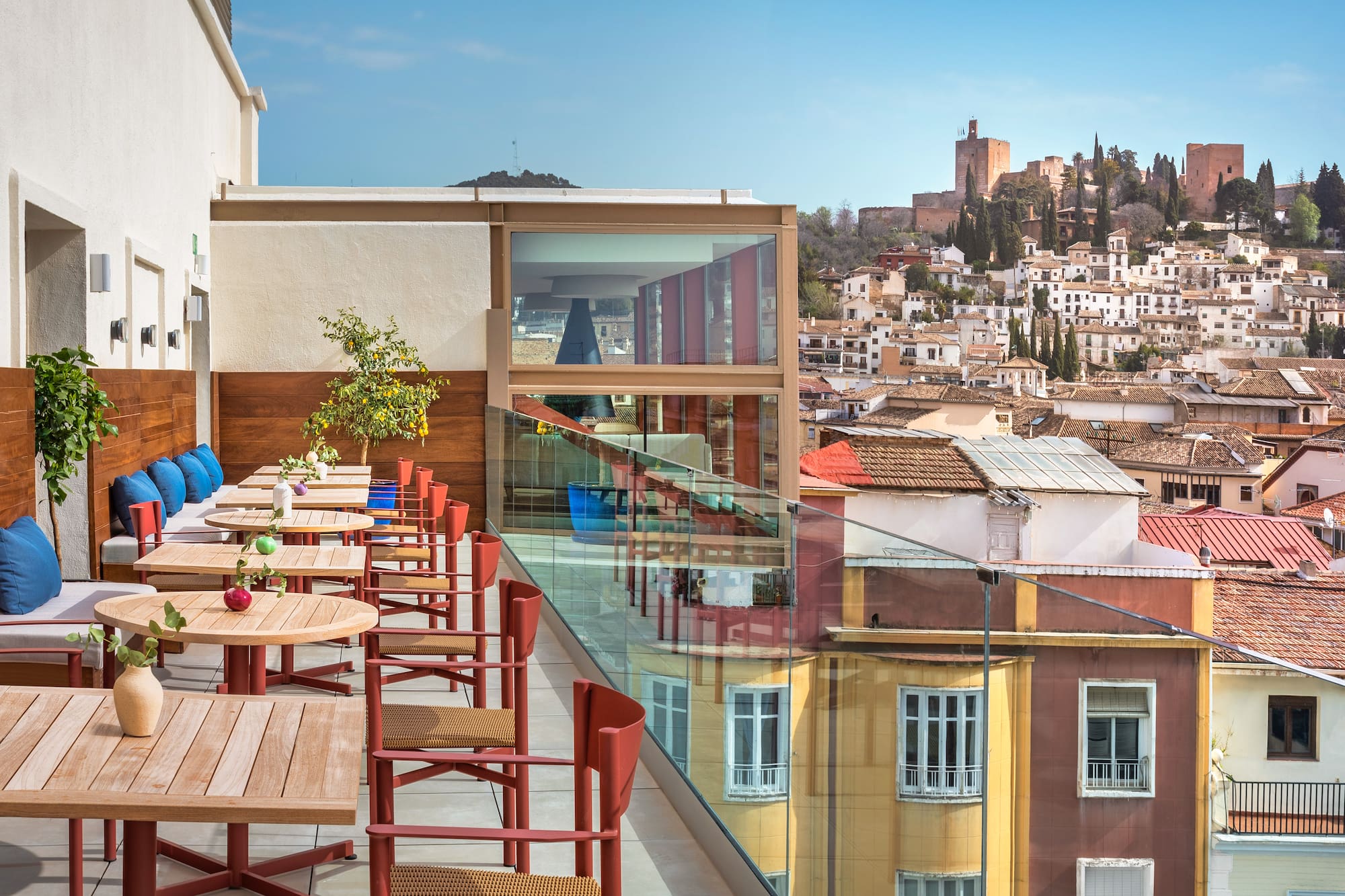 a table and chairs on a balcony overlooking a city