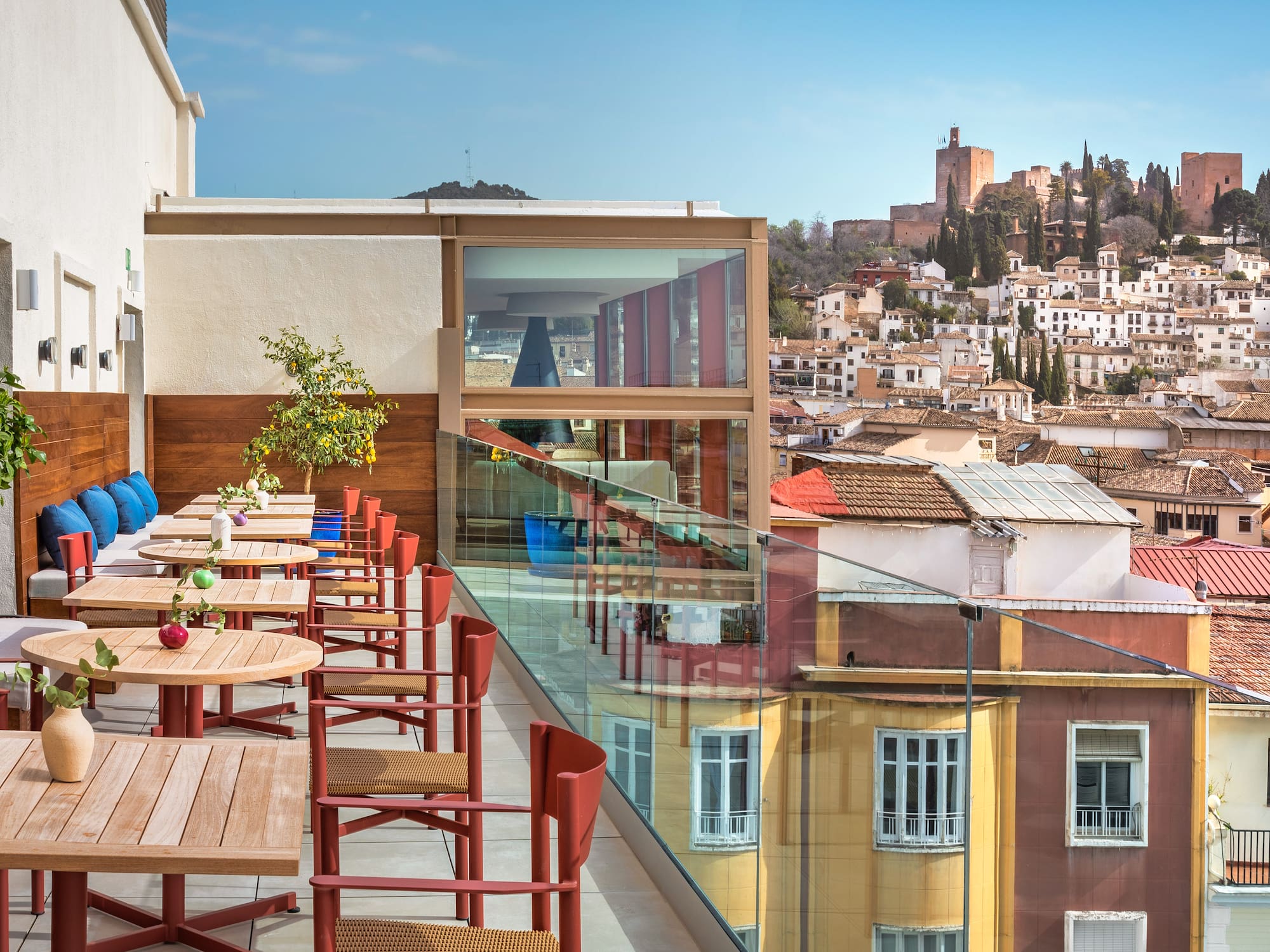 a table and chairs on a balcony overlooking a city
