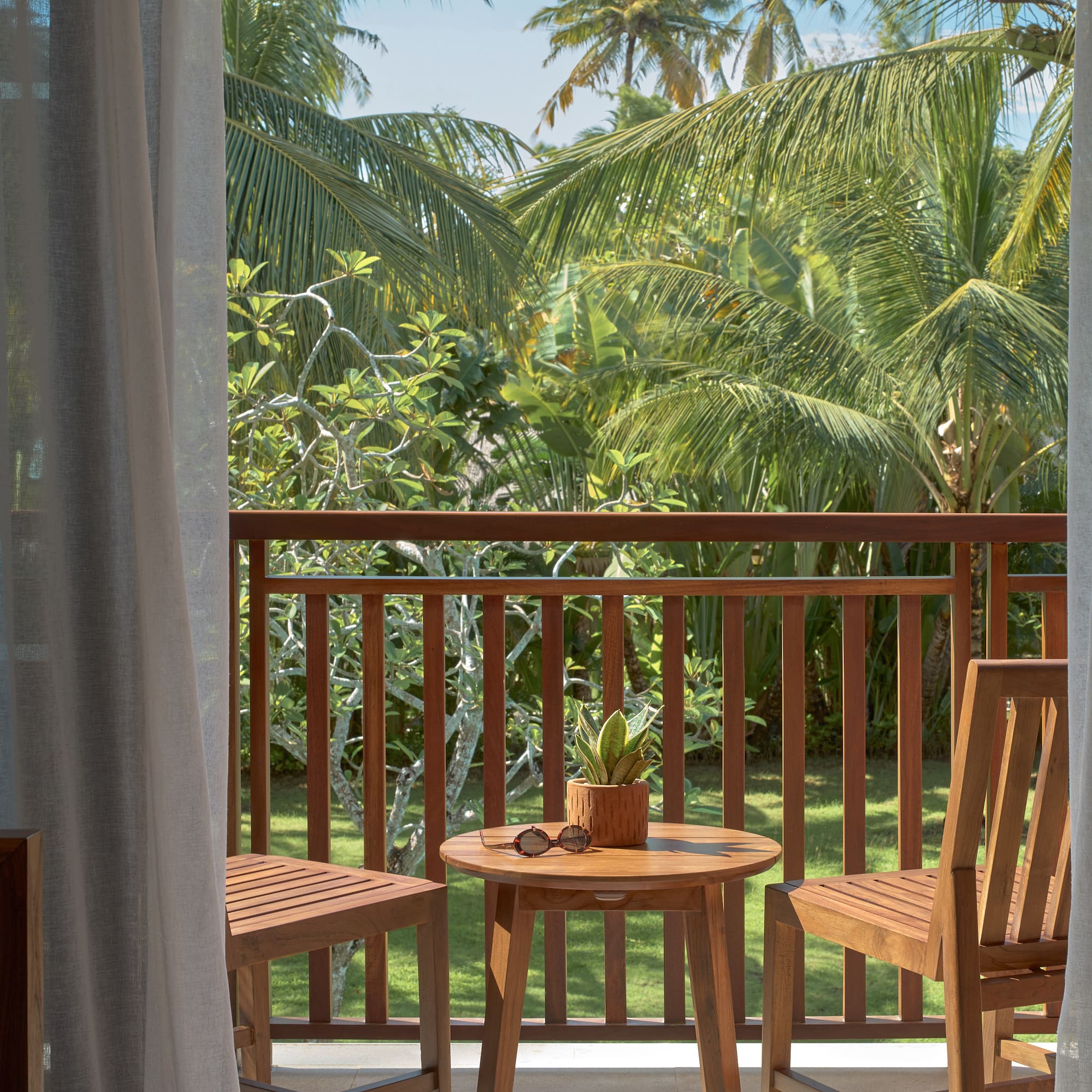 a table and chairs on a balcony