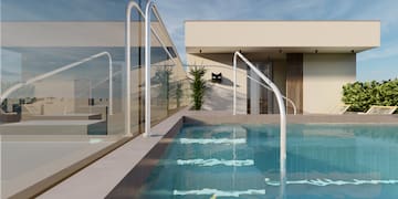 a pool with railings in front of a house