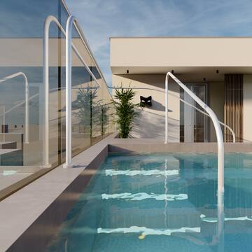 a pool with railings in front of a house