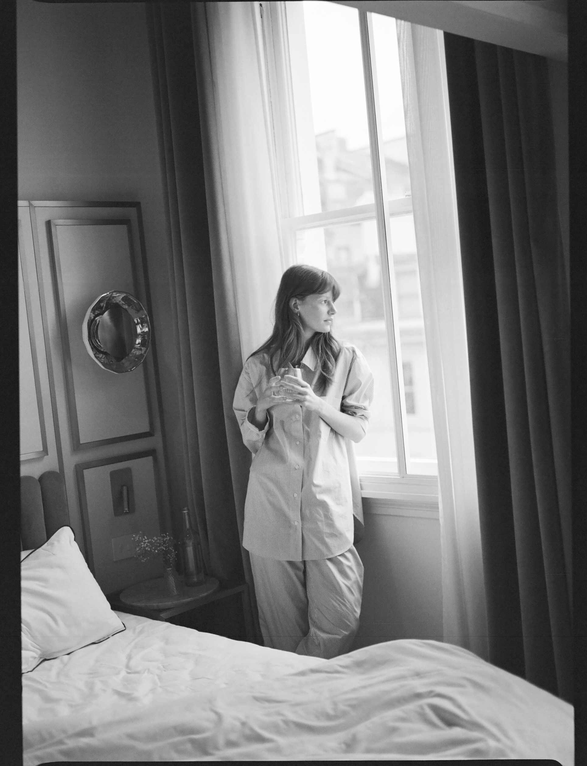 a woman standing in front of a window