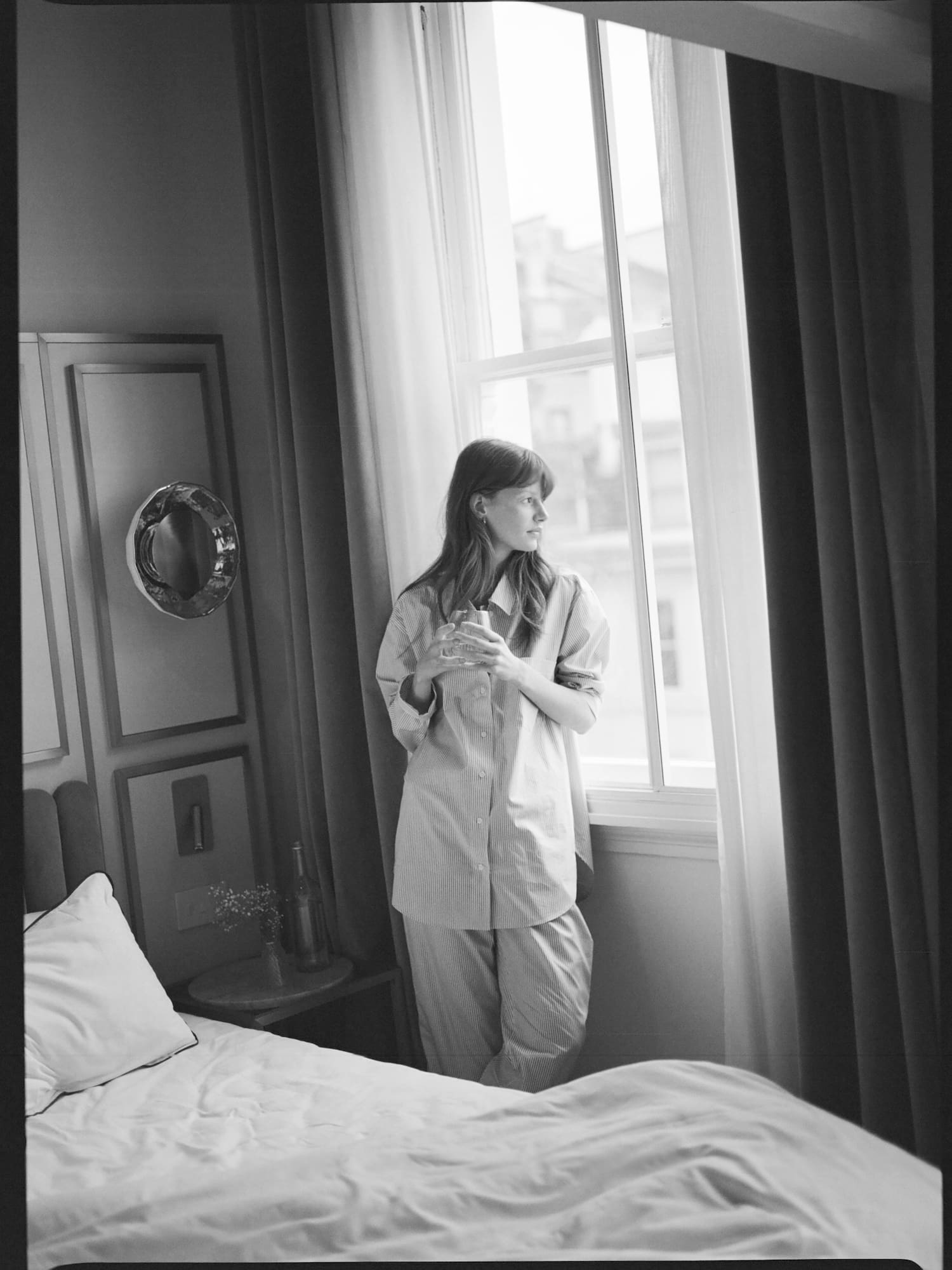 a woman standing in front of a window