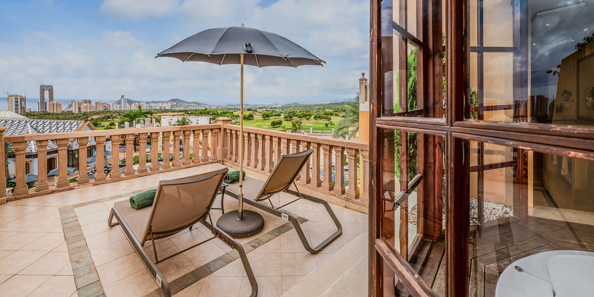 a patio with chairs and umbrella