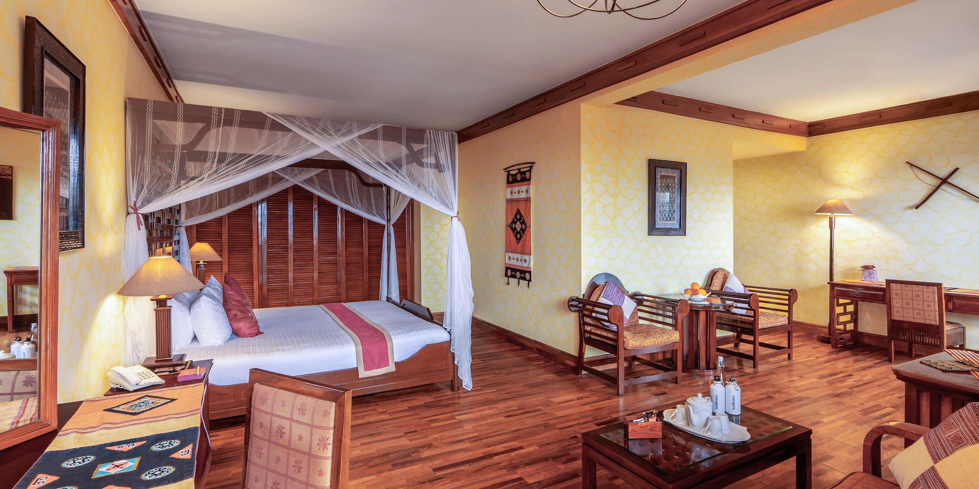 a room with a bed and chairs