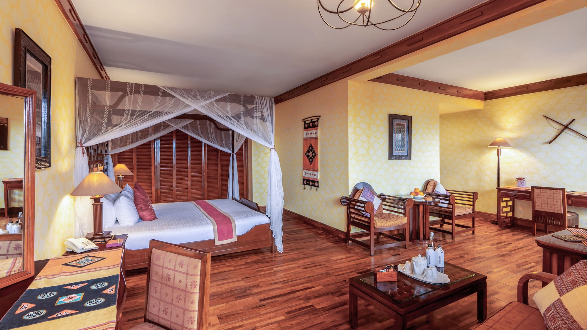 a room with a bed and chairs