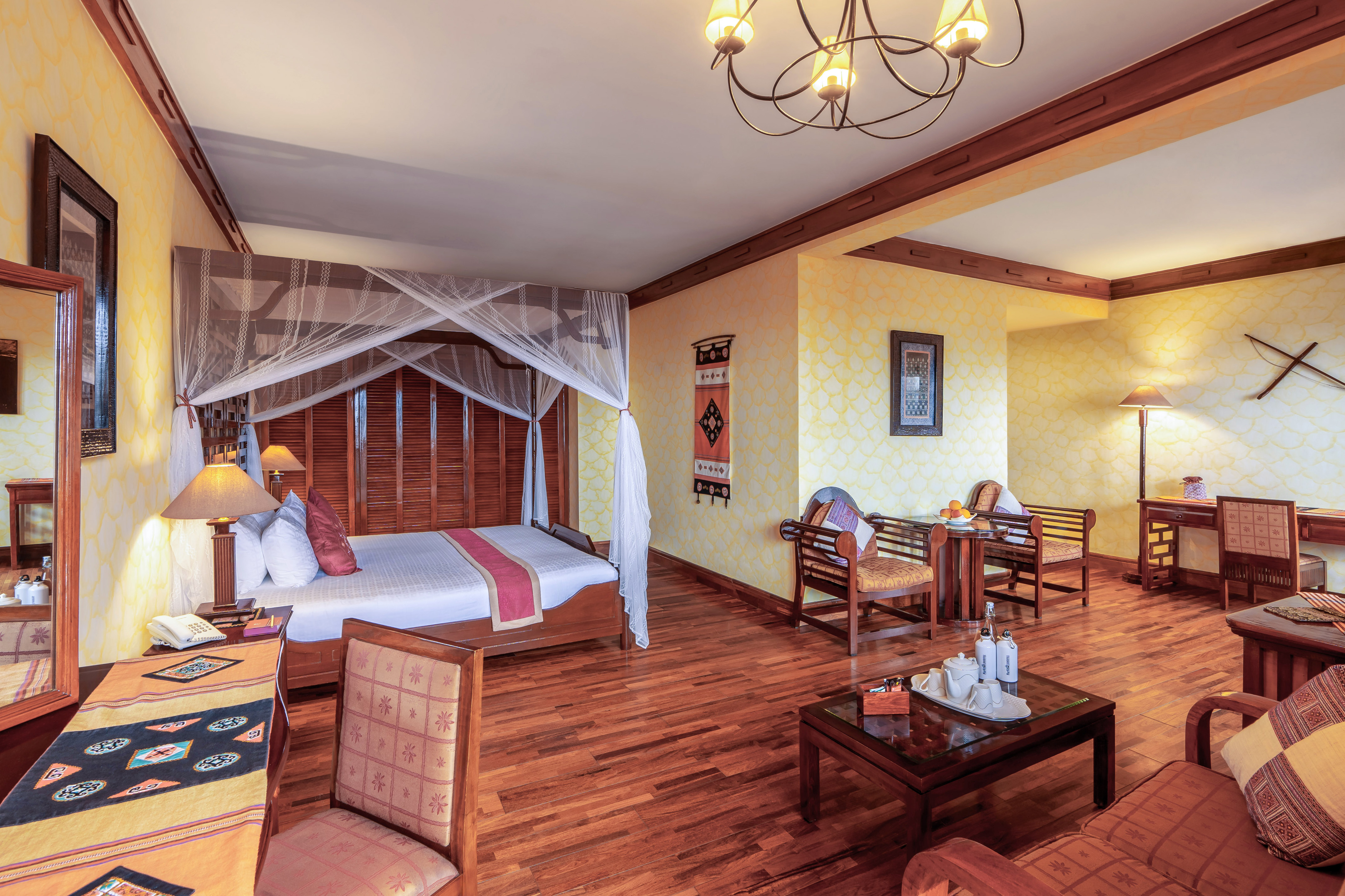 a room with a bed and chairs