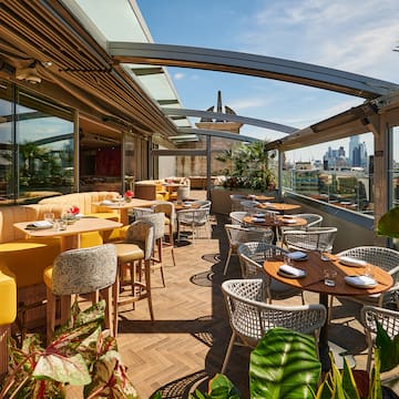 a restaurant with tables and chairs on a patio