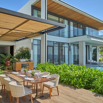 a table and chairs outside of a house