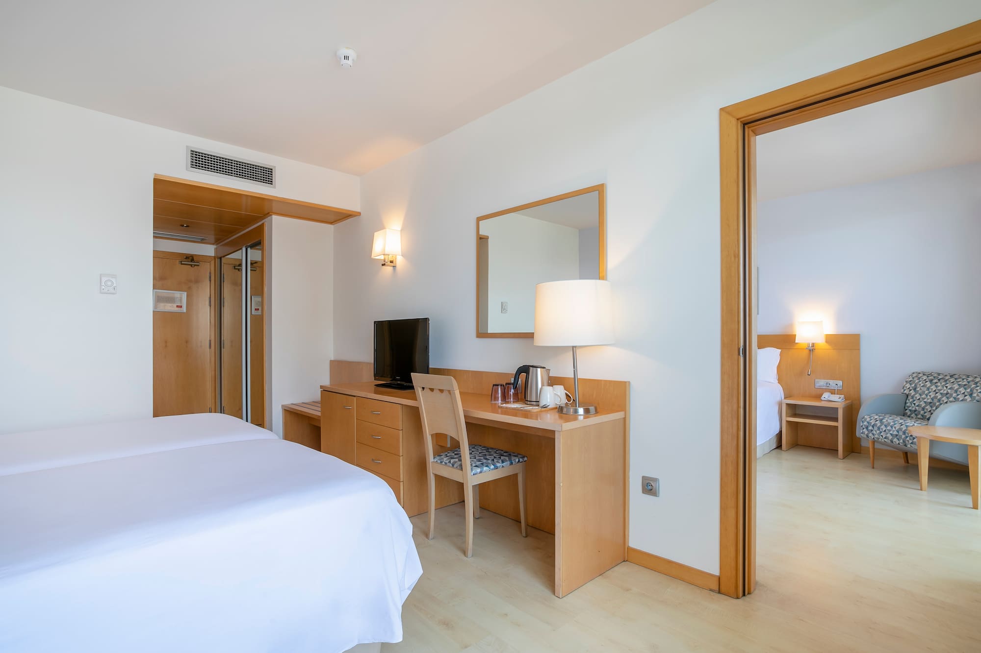 a room with a bed and a desk