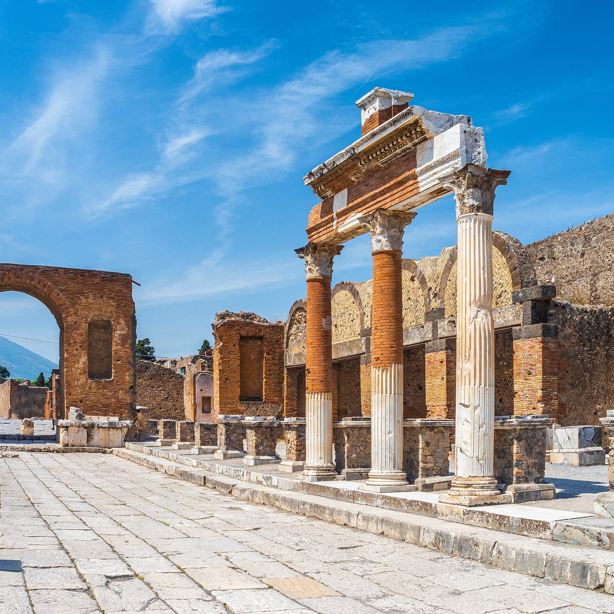 an old stone building with columns and arches