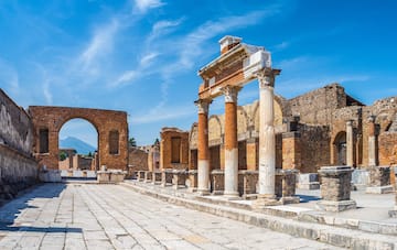 an old stone building with columns and arches