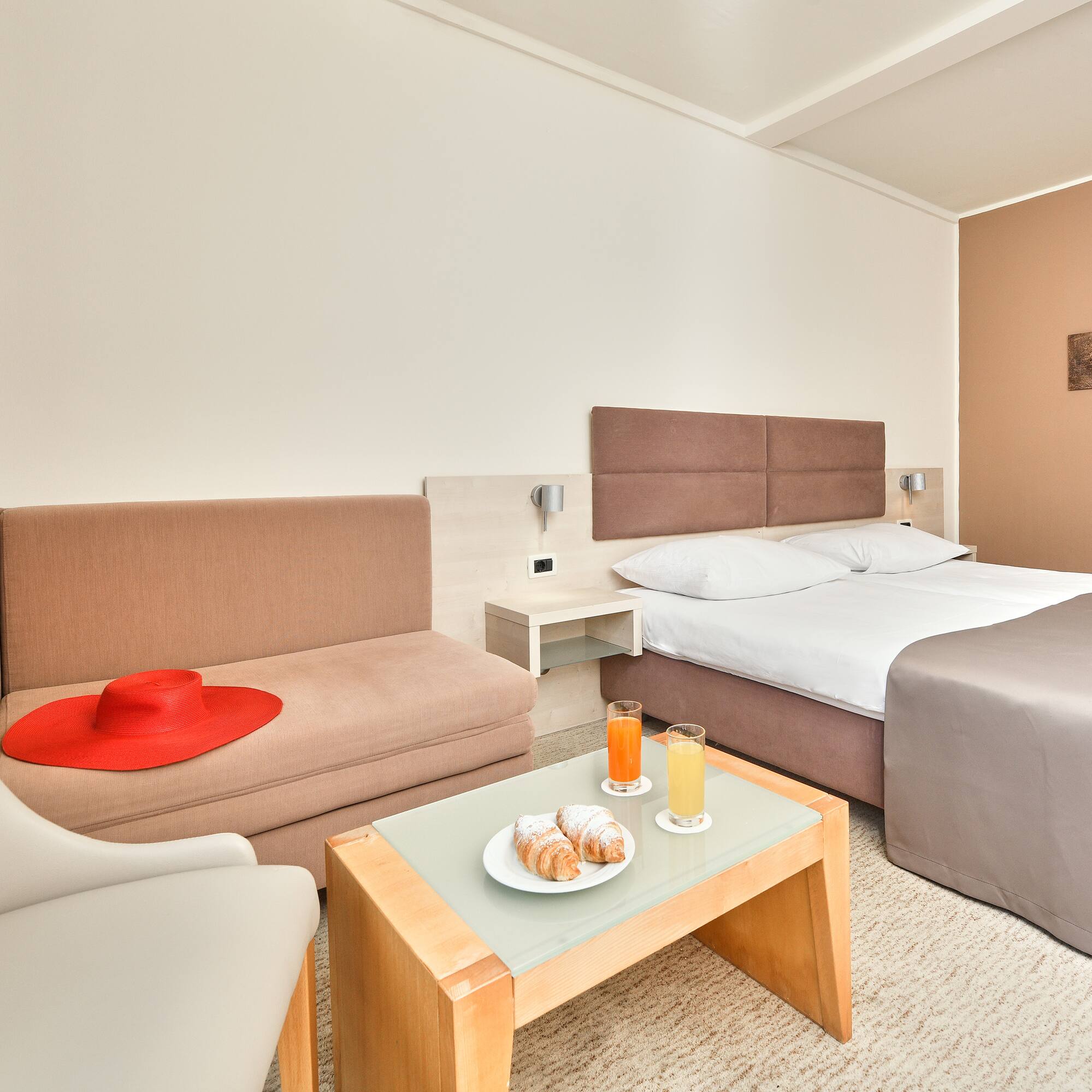 a room with two beds and a table with food and drinks