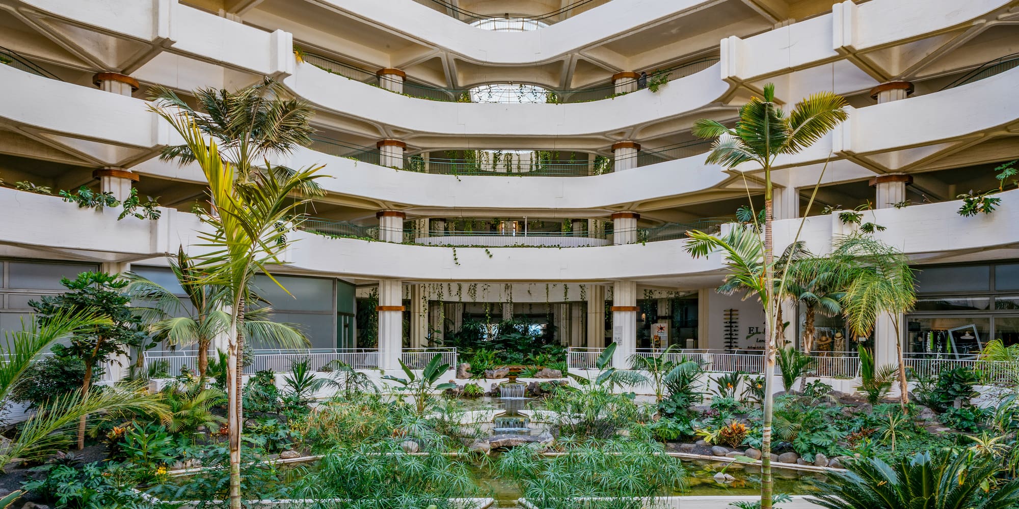 a courtyard with a waterfall and trees