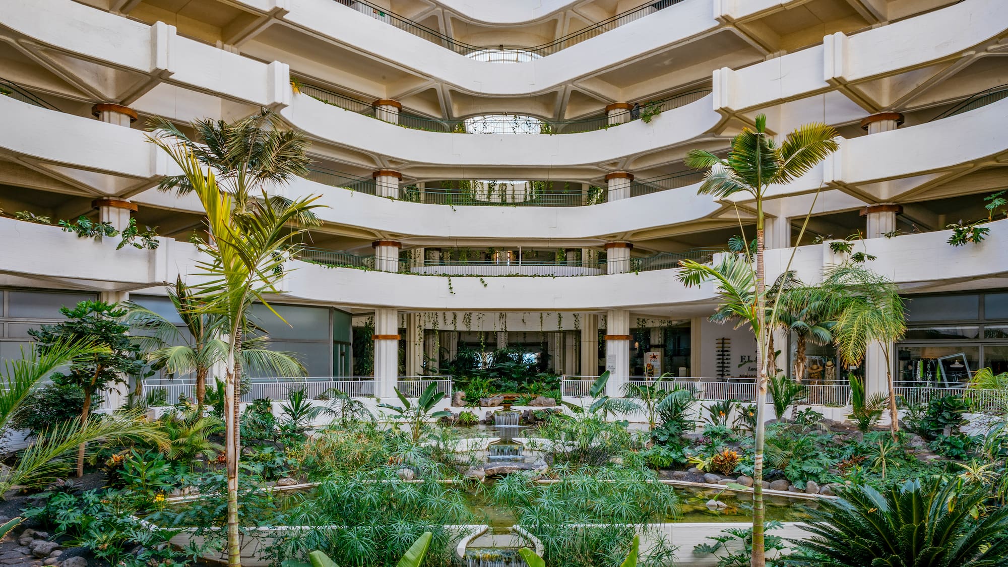 a courtyard with a waterfall and trees
