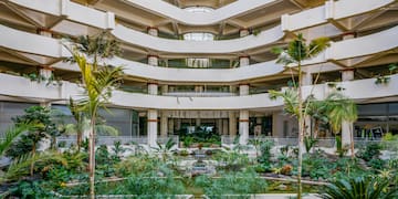 a courtyard with a waterfall and trees