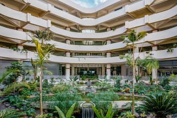 a courtyard with a waterfall and trees