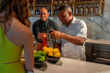 a group of people standing around a table