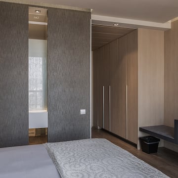 a room with a bed and a bench