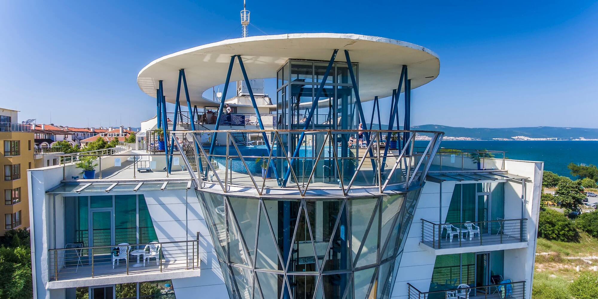 a building with glass walls and a glass balcony