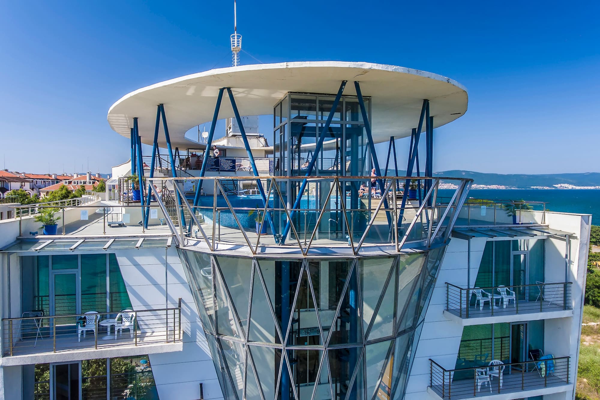 a building with glass walls and a glass balcony