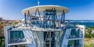 a building with glass walls and a glass balcony