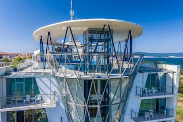 a building with glass walls and a glass balcony