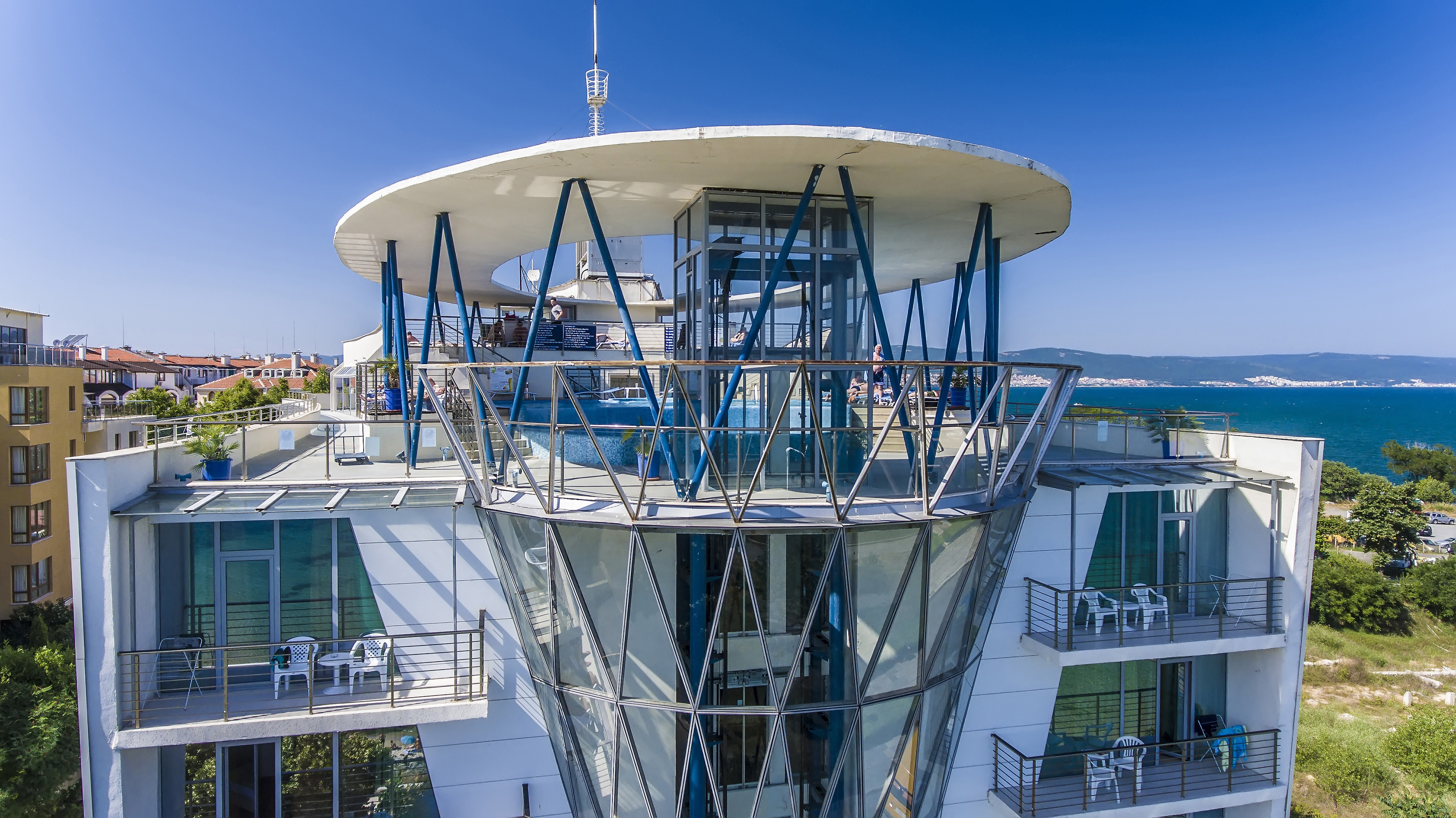 a building with glass walls and a glass balcony