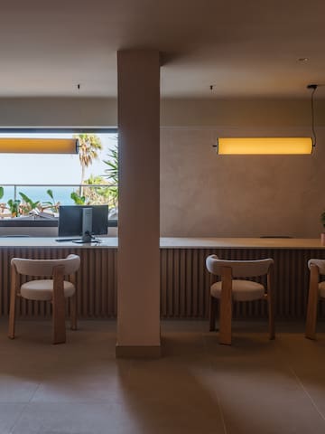 a room with a desk and chairs